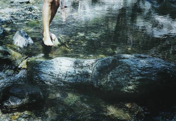 istock young girl walking on the river 689979478