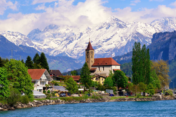 Brienz town near Interlaken and snow covered Alps mountains, Switzerland Brienz town on Lake Brienz by Interlaken, Switzerland, with snow covered Alps mountains in background grindelwald photos stock pictures, royalty-free photos & images