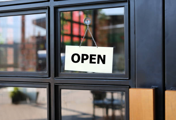 istock Open sign board hanging on door of cafe. 689979708