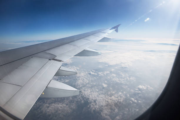 istock Wing of an airplane flying above the clouds 689983690