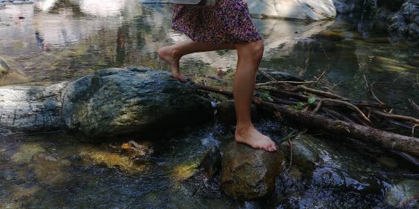 young girl walking on the river