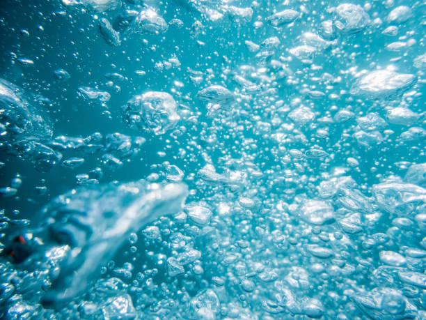 istock Bubbles and sun rays in underwater, diving in blue ocean. Water texture. 689986746