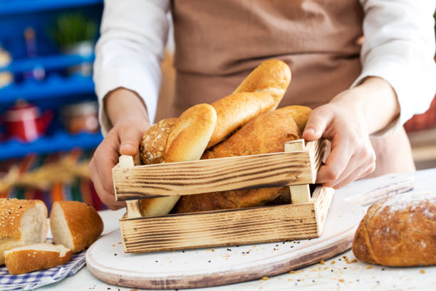 istock Female hands holding freshly bread in crate 689990064
