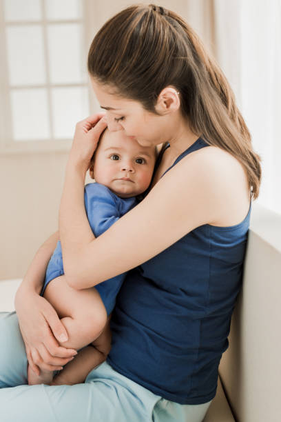 istock mother hugging her son with tenderness 689990288