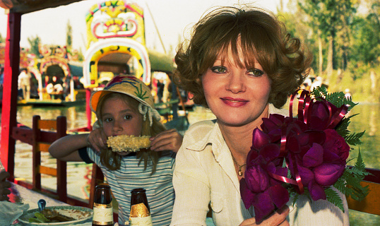 Image form the eighties featuring a woman with her daughter on a mexican boat in Xochimilco