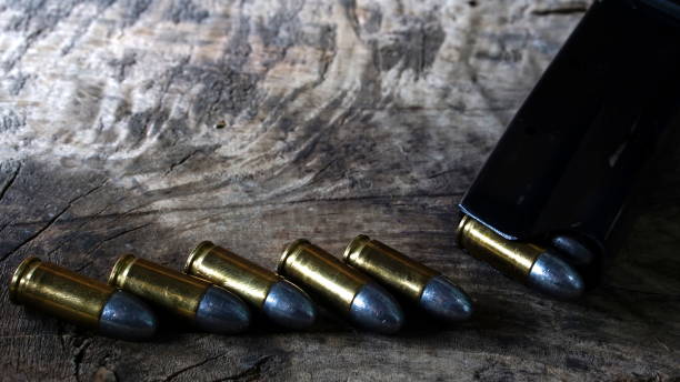 istock Bullets and a firearm on the wood 689993620