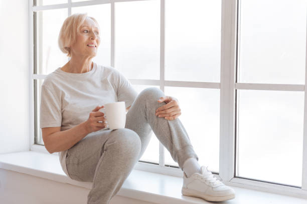 istock Relaxed woman looking through the window 689993780