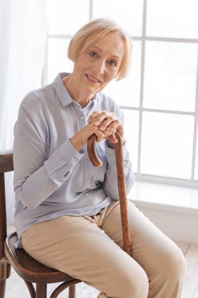istock Elegant lady leaning on walking stick 689993958