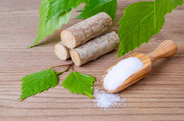 sugar substitute xylitol, scoop with birch sugar, liefs and wood sugar substitute xylitol, a scoop with birch sugar, liefs and wood on wooden background birch tree photos stock pictures, royalty-free photos & images