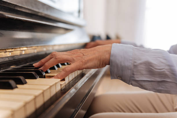 istock Close up of female hand while playing the piano 689997174
