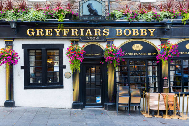 pub at the Greyfriars Kirkyard, Edinburgh, UK Edinburgh, Scotland - September 09, 2016: pub at the Greyfriars Kirkyard. The The name Greyfriars Bobby is dedicated to a loyal dog, who guarded his masters grave for years kirkyard stock pictures, royalty-free photos & images