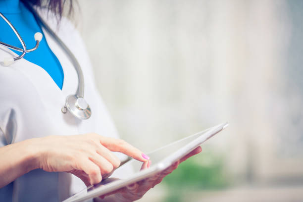 istock Doctor working on a digital tablet with copy space 689997552