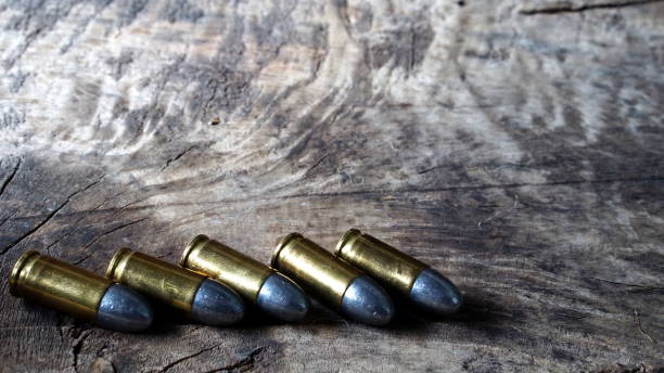 istock Bullets and a firearm on the wood 689998102