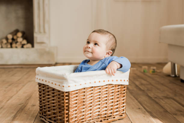 istock little baby boy sitting inside of braided box 689998398