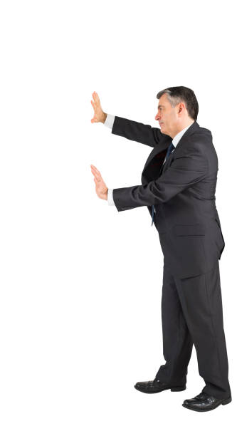 istock Mature businessman pushing with hands 690000762