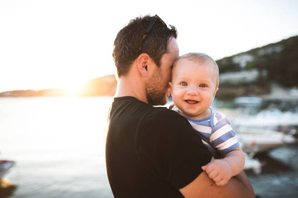 istock Man with baby son enjoying their time at seaside. 690001054