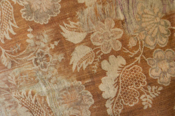 istock Rust colored cotton fabric with pattern of flowers and leaves 690001544