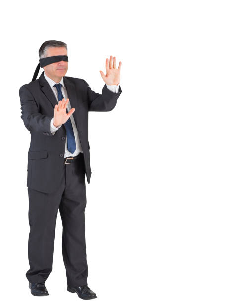 istock Mature businessman walking with blindfold 690001848