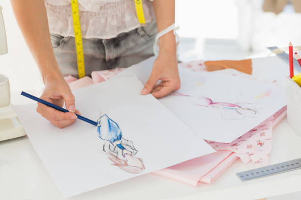 istock Mid section of a fashion designer working on her designs 690001924