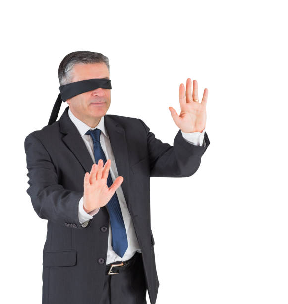 istock Mature businessman walking with blindfold 690001936