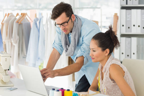 istock Fashion designers using laptop in studio 690002454