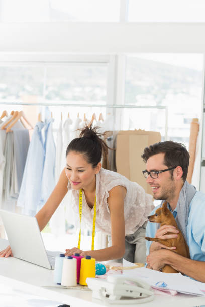 istock Fashion designers using laptop in studio 690002524