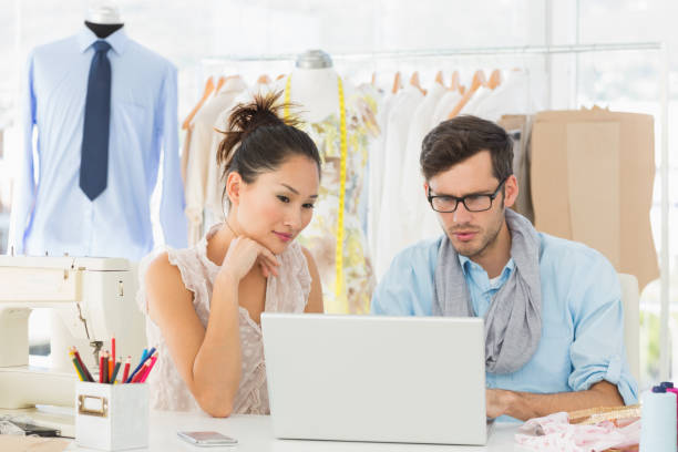 istock Fashion designers using laptop in studio 690002586