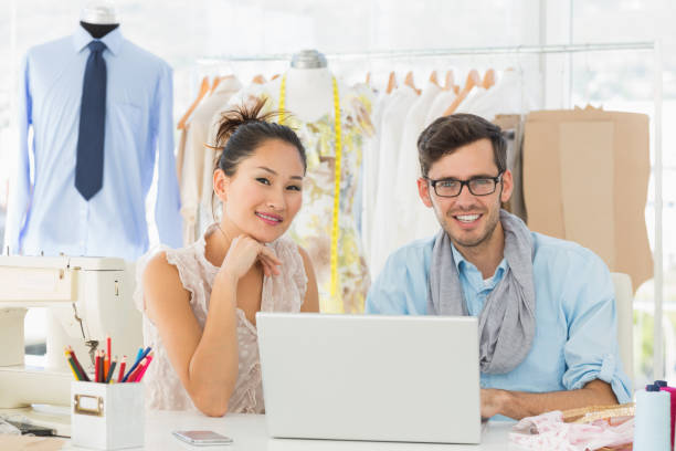 istock Fashion designers using laptop in studio 690002612
