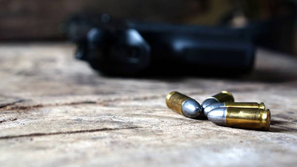 istock Bullets and a firearm on the wood 690005112