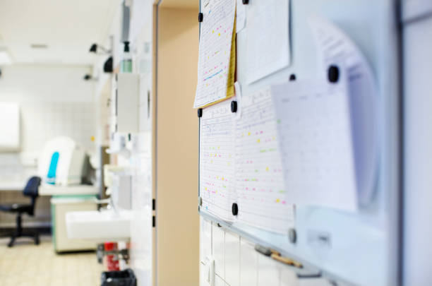 Close-up of bulletin board in laboratory. Test results attached on board over wall. It is in hospital.