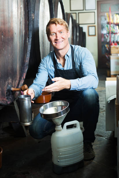istock Male seller in wine cellar 690009090