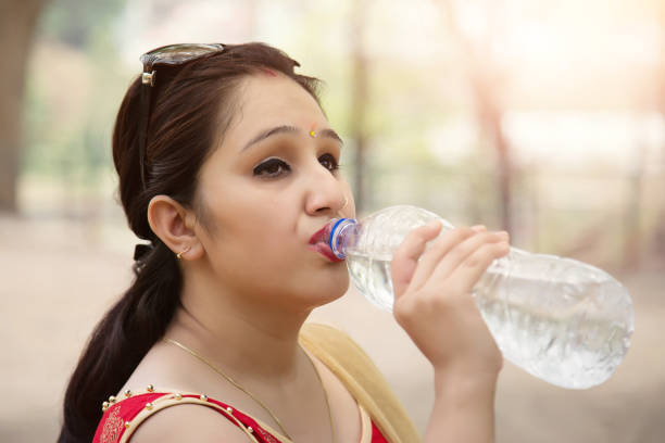 istock Young woman drinking water. 690009828