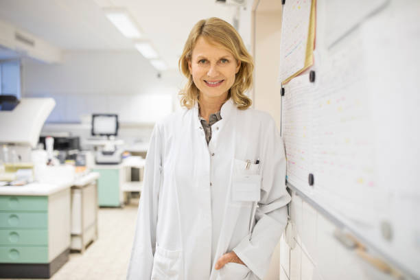 istock Mature female scientist standing by bulletin board 690010458
