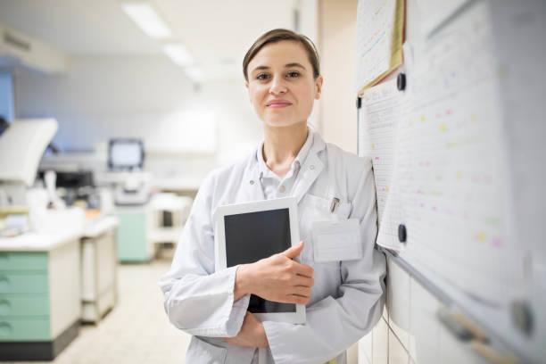 istock Confident female doctor holding digital tablet 690010524