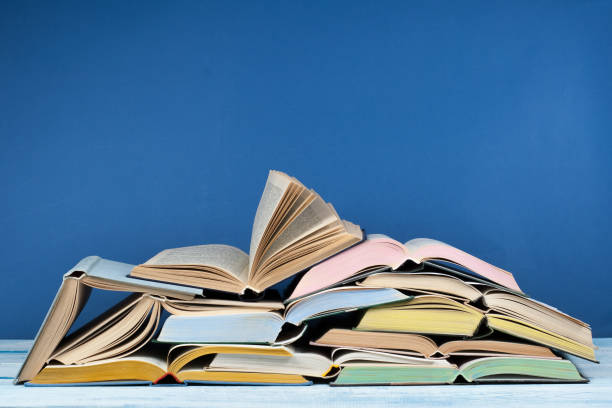 istock Open book, hardback colorful books on wooden table. Back to school. Copy space for text. Education business concept 690010830