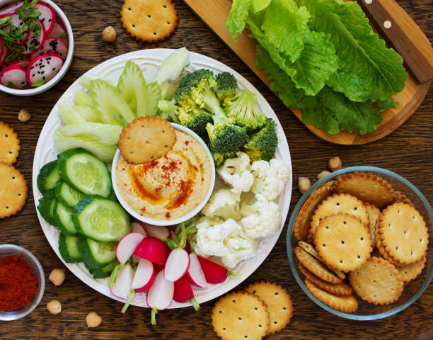 istock homemade hummus with raw vegetables. 690013076