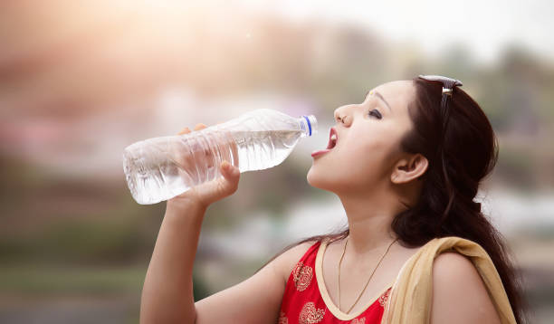istock Young woman drinking water. 690016326