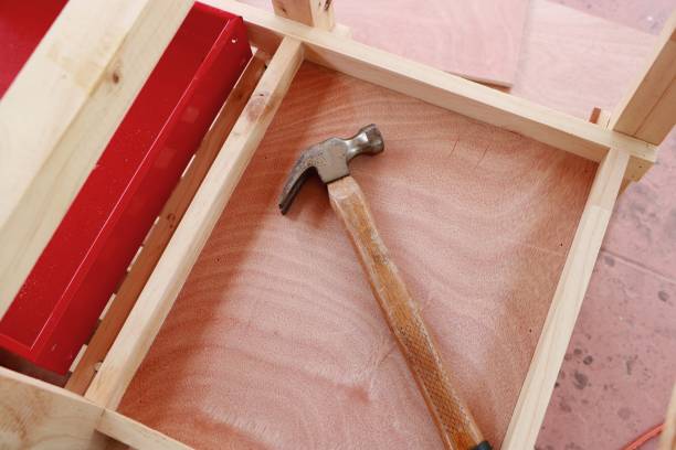 Hammer on wooden framework background stock photo