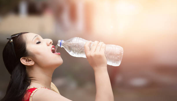 istock Young woman drinking water. 690018900