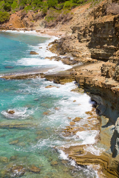 istock Rocks and ocean waves. Antigua, English Harbour 690028076