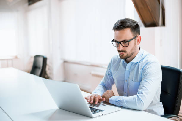 istock Young businessman working with laptop at office 690028926