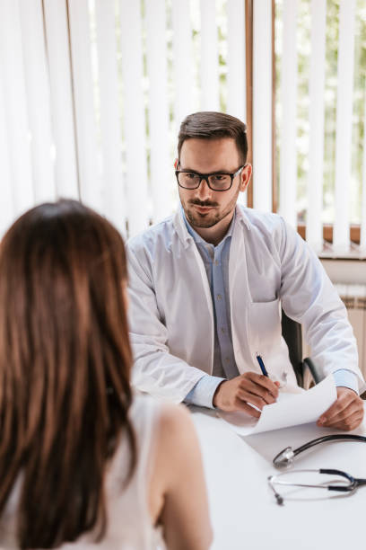 istock Serious doctor listening to patient 690029130