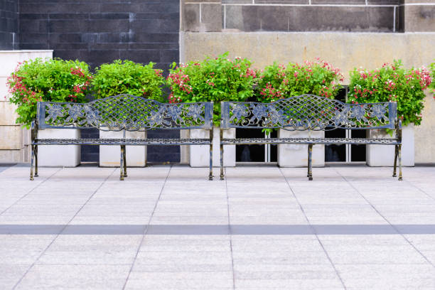 istock Metal bench among the flower garden. 690032614