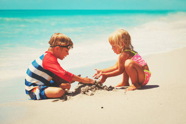 istock kids play with sand on summer beach 690035456