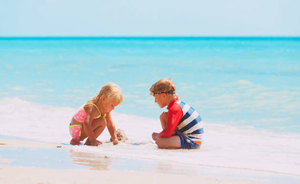 istock kids play with sand on summer beach 690035876