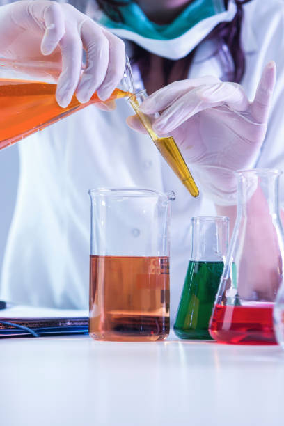 istock Closeup of hands of Female Laboratory Worker Dealing With Flasks 690036250
