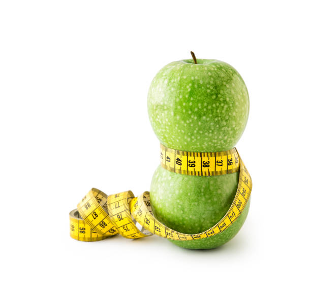 istock Green Apples with Measuring Tape , isolated 690039242
