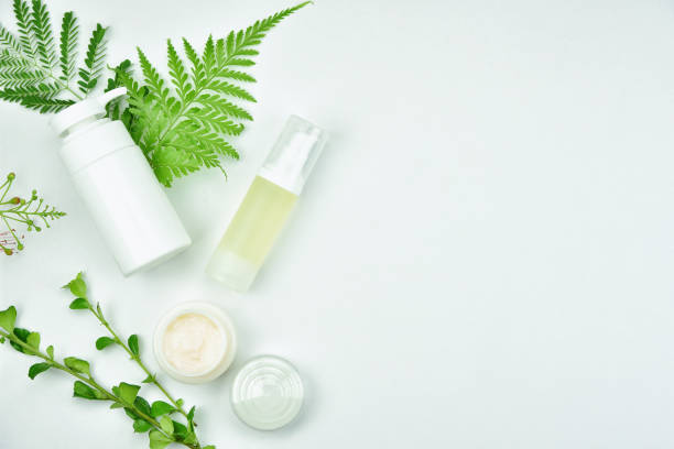 istock Cosmetic bottle containers with green herbal leaves, Blank label package for branding mock-up, Natural organic beauty product concept. 690043308