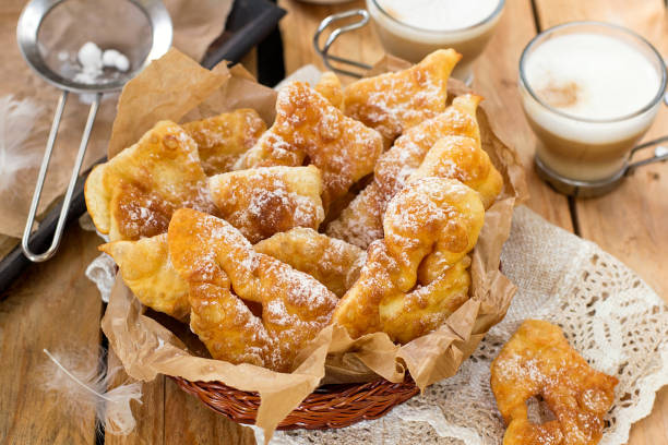 Sweet crisp pastry Angel wings with powdered sugar Sweet crisp pastry Angel wings with powdered sugar for coffee beignet stock pictures, royalty-free photos & images