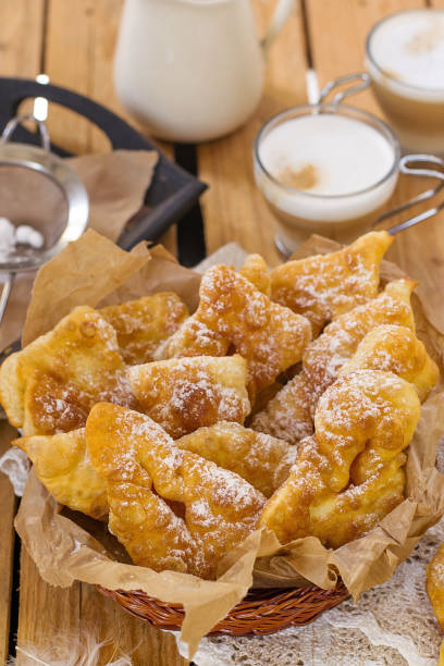 istock Sweet crisp pastry Angel wings with powdered sugar 690046676